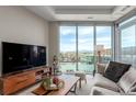 Sunlit living room with floor-to-ceiling windows showcasing panoramic views of the city and mountains at 4200 W 17Th Ave # 508, Denver, CO 80204