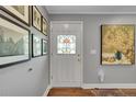 Bright foyer featuring hardwood floors, a decorative stained glass front door, and stylish wall decor at 9225 Lowell Blvd, Westminster, CO 80031