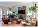 Spacious living room with a stone fireplace and hardwood floors at 13304 E Asbury Dr, Aurora, CO 80014