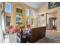 Elegant living room with high ceilings, large windows, and stylish decor at 6584 S Sedalia St, Aurora, CO 80016