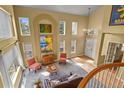 Bright, open living room with high ceilings, large windows, and stylish decor at 6584 S Sedalia St, Aurora, CO 80016