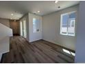 Bright living room with hardwood floors, large windows, and ample natural light at 6658 N Nepal Ct, Aurora, CO 80019