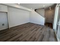 Spacious living area with hardwood floors, staircase, and adjacent closet space at 6658 N Nepal Ct, Aurora, CO 80019