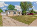 A well-maintained single-story home showcasing its neat lawn and inviting curb appeal on a sunny day at 1023 S Alcott St, Denver, CO 80219