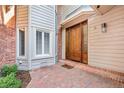 Inviting front entrance showcasing a beautiful wood door, brick accents, and manicured landscaping at 2552 E Alameda Ave # 74, Denver, CO 80209