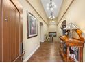 Elegant foyer with gleaming hardwood floors, stylish lighting, and sophisticated decor creates a warm welcome at 2317 Primo Rd # A, Highlands Ranch, CO 80129