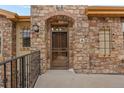 Close-up view of the front door with a stone surround and unit number 'A' at 2317 Primo Rd # A, Highlands Ranch, CO 80129