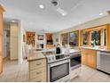 Open kitchen with stainless appliances, center island with breakfast bar, and adjacent living room at 7162 S Fillmore Cir, Centennial, CO 80122