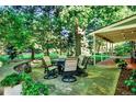 Outdoor patio showcasing a dining set, perfect for enjoying meals alfresco in a serene setting at 56 Spyglass Dr, Littleton, CO 80123