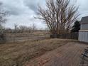 Backyard enclosed with chain link and wooden fences, features a brick paver patio at 17605 E Temple Dr, Aurora, CO 80015