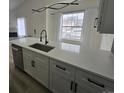 Bright kitchen featuring quartz countertops, stainless steel appliances, and modern black hardware at 17605 E Temple Dr, Aurora, CO 80015