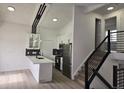 Modern kitchen featuring white cabinets, a stylish black backsplash, and stainless steel appliances at 17605 E Temple Dr, Aurora, CO 80015