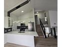 Modern kitchen featuring white cabinets, stainless steel appliances, and a breakfast bar with seating at 17605 E Temple Dr, Aurora, CO 80015