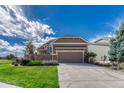 House exterior showcasing a two-car garage and well-maintained landscaping at 22178 E Stroll Ave, Parker, CO 80138