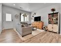 Bright living room with wood floors, neutral decor, and comfortable seating arrangement at 6350 N Lisbon St, Aurora, CO 80019