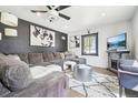 Modern living room features a large sectional sofa, fireplace, and stylish decor at 1325 S Clermont St, Denver, CO 80222