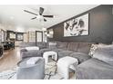 Spacious living room with comfortable seating, contemporary art, and a ceiling fan at 1325 S Clermont St, Denver, CO 80222