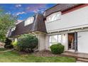 Charming home with well-maintained landscaping, inviting entrance, and a mix of brick and siding accents at 6328 E Mississippi Ave, Denver, CO 80224