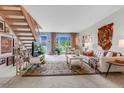 Spacious living room boasts a cozy area rug, comfortable seating, and a staircase leading to the upper level at 6328 E Mississippi Ave, Denver, CO 80224