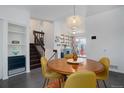Charming dining area featuring a round table, dark wood stairs, and custom built-in shelves at 4922 S Salida Ct, Aurora, CO 80015