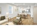 Open-concept living room with ample seating and natural light adjacent to a bright kitchen at 23721 E 40Th Ave, Aurora, CO 80019