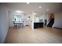 Expansive open floor plan showcasing the kitchen, dining area, and living space with contemporary finishes at 1552 S Fairplay Way, Aurora, CO 80012