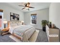 Cozy bedroom with plush carpet, large window, and soft, neutral furnishings at 2245 Whistler Dr, Longmont, CO 80504