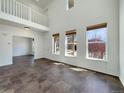Open living room with abundant natural light and neutral-colored tile flooring throughout at 2245 Whistler Dr, Longmont, CO 80504