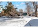 Rear view of house with snow covered yard at 950 S Leyden St, Denver, CO 80224