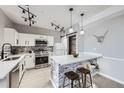 Well-lit kitchen with stainless steel appliances, modern backsplash and white cabinets and island at 2151 Enterprise St, Superior, CO 80027