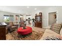 Open-concept living room featuring hardwood floors, light-colored walls, and backyard access at 5417 Riverbend Ave, Firestone, CO 80504