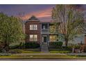 Charming two-story brick home with a lovely front porch viewed at dusk at 3542 W 125Th Dr, Broomfield, CO 80020