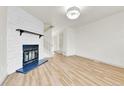 Cozy living room featuring fireplace, wood floors, and staircase at 11935 E Ford Dr, Aurora, CO 80012