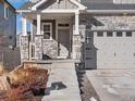 Inviting front entrance with stone accents and a covered porch for a welcoming appeal at 21901 E 42Nd Place, Aurora, CO 80019