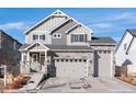 Charming home with stone accents, a three-car garage, and landscaped front yard under blue skies at 21901 E 42Nd Place, Aurora, CO 80019