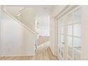 Bright entryway with light hardwood floors and french doors at 20690 E 58Th Ave, Aurora, CO 80019