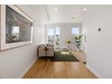 Cozy living room featuring a sofa, balcony access, and a stylish coffee table with modern decor at 1810 Irving St # 8, Denver, CO 80204