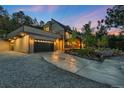 Beautiful modern home with a two-car garage, driveway, and manicured landscaping at 1298 Meadow View Dr, Evergreen, CO 80439