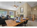 Inviting living room with a cozy fireplace, adjacent dining area, and backyard access at 9860 Burberry Way, Highlands Ranch, CO 80129