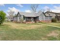 Exterior of a home with brick foundation and lush green lawn at 4595 S Fox St, Englewood, CO 80110