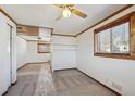 Bedroom with neutral carpet, wood trim, ceiling fan, and natural light from two windows at 11782 Gilpin St, Northglenn, CO 80233