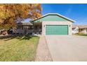 Brick ranch home with green accents and a two-car garage at 1040 S Fulton Ave, Fort Lupton, CO 80621