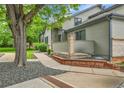 Side exterior of a home with a brick accent wall and mature trees at 9183 W Cedar Dr # 2, Lakewood, CO 80226