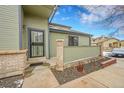 Welcoming front entrance with beautiful door design and manicured landscaping at 9183 W Cedar Dr # 2, Lakewood, CO 80226