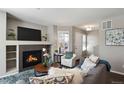 Comfortable living room featuring a fireplace, TV, and lots of comfortable seating at 14300 Waterside Ln # S2, Broomfield, CO 80023