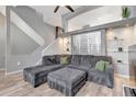 Stylish living area with gray sectional sofa, wood floors, and modern design elements at 1465 Red Cliff Way, Castle Rock, CO 80109