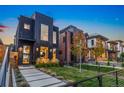 Contemporary black home with manicured front yard, modern design and large windows, showcasing sophisticated urban living at 3709 Tejon St, Denver, CO 80211