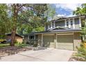Lovely exterior displaying a two-car garage, and a spacious front yard at 7150 S Curtice St, Littleton, CO 80120