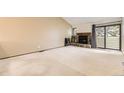 Spacious living room with a stone fireplace and sliding glass doors at 4162 S Richfield S Way, Aurora, CO 80013
