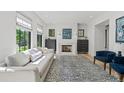 Bright living room with large windows, stylish decor, fireplace and modern furniture at 1265 S Gaylord St, Denver, CO 80210